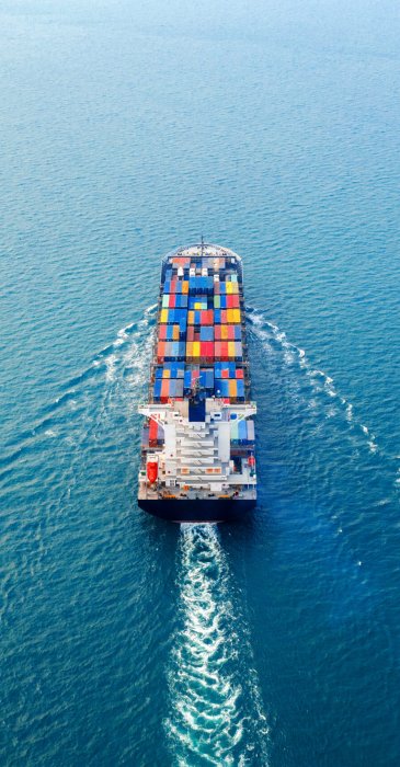 Aerial view of container cargo ship in sea.